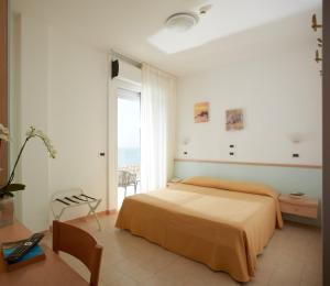 利尼亚诺萨比亚多罗伯利坎酒店的一间卧室设有一张床和一个大窗户