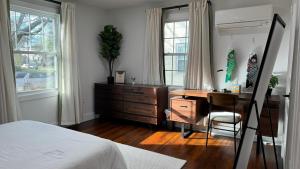 巴吞鲁日Garden District Duplex的一间卧室配有书桌、一张床和一把椅子