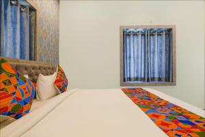 海得拉巴FabHotel Lio7 Grand的一间卧室设有一张床和一个窗口