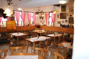 巴特朗根萨尔察Gasthaus Zur Weintraube的餐厅设有木桌、椅子和窗户。