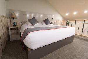 科米坦德多明格斯Collection O Corazón Del Café Hotel Boutique的卧室配有一张带白色床单和枕头的大床。