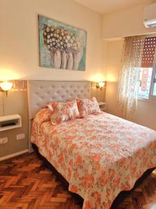 布宜诺斯艾利斯Centro de Buenos Aires的一间卧室配有一张带花卉床罩的床