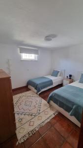 佩纳科瓦Retiro do Viajante的一间带两张床的卧室和地毯