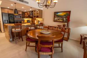 新巴利亚塔Grand Marina Villas的厨房以及带木桌和椅子的用餐室。