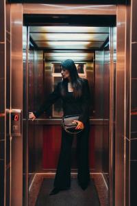 巴尼亚卢卡Wellness Spa Hotel Jola的站在电梯里的一个有蓝色头发的女人