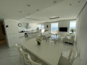 内坦亚Netanya Dream Luxury Apartment MIGDAL DAVID的白色的客厅配有桌椅