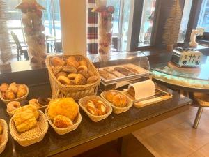 锡默拉特Garni Hotel Henn的自助餐,包括一篮面包和糕点