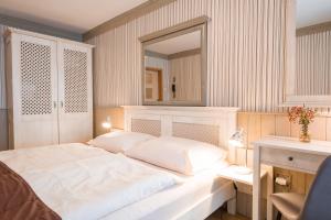 弗林布尔克玛谢特酒店的卧室配有一张带镜子的白色大床