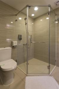 高雄麗馨商旅七賢館的浴室设有玻璃淋浴间和卫生间