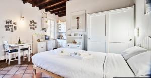 米兰Navigli Elyon apartment的卧室配有白色的床和桌子
