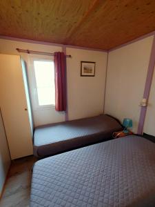 Autry-le-ChâtelLes Chalets du Quignon的一间小卧室,配有床和窗户