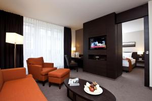 吕贝克吕贝克阿特兰蒂克酒店的一间酒店客房,配有沙发,一间客房,配有一张床