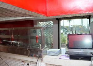 AsiHexagon Hotel的一间带电视和电视的柜台的厨房