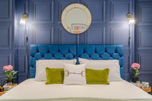 切尔滕纳姆Regency Basement Apartment的蓝色卧室,配有一张蓝色床头板的床
