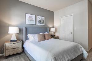 蒙特朱丽叶Landing Modern Apartment with Amazing Amenities (ID4039X27)的一间卧室配有一张床和一个带两盏灯的床头柜。