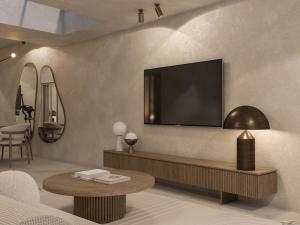易莫洛林安德罗尼斯概念健康度假村的客厅设有壁挂式平面电视。