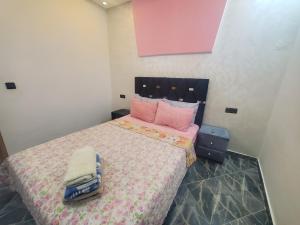 舍夫沙万Dar Brahim的卧室配有一张带粉红色枕头的大床