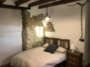 蒙特弗里奥4 bedrooms house with shared pool and wifi at Granada的一间卧室设有一张床和石墙