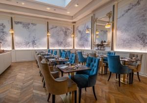 佛罗伦萨金塔温泉酒店的一间配备有桌子和蓝色椅子的用餐室
