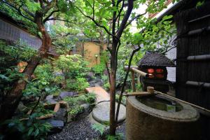 京都桑加旅馆的一个带小池塘和雕像的花园