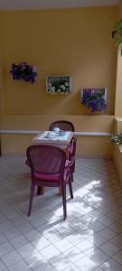 卡拉古诺内Affittacamere Casa del Sole的鲜花客房内的桌椅