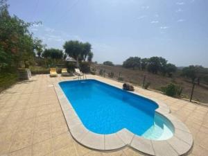CurvatosSerra do Caldeirao Villa with Pool的庭院里设有一个大型游泳池,