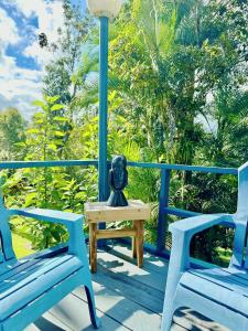 Hacienda Verde Luz的蓝色的门廊,配有2把蓝色的椅子和桌子