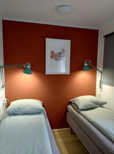AnnerveenschekanaalDrenths Landgoed, Lekker uit的红色墙壁的客房内的两张床