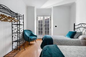 拉奥罗塔瓦La Planta Vieja的一间卧室配有两张床和一张蓝色椅子