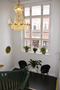 诺尔雪平Best Guest Vandrarhem的窗户间里的吊灯和椅子