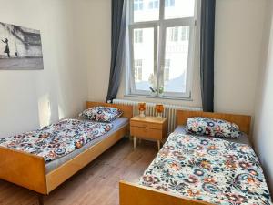 不来梅港Gemütliche Retro Wohnung的一间卧室设有两张床和窗户。