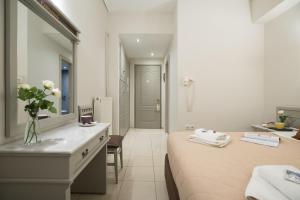 特尔斐巴纳索斯德尔菲酒店的一间卧室配有床、水槽和镜子
