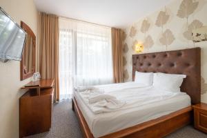 西格伏沙尔克Complex Katalina的一间卧室配有一张带白色床单的床和一扇窗户。