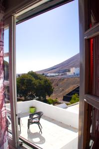Montaña Blancahotel rural GA7COLORES only adult的阳台享有房屋的景致,配有桌椅
