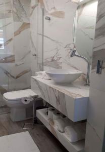 巴西利亚Flats Asa Norte CLN 110 by CentoEdez的白色的浴室设有水槽和卫生间。