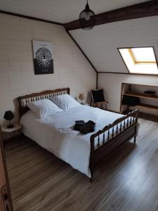 Rigny-la-NonneuseLa Grange Aux Fleurs的一间卧室配有一张大床和一架钢琴