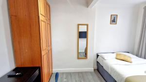 WansteadPeaceful & Private 2-Bedroom Suite - A London Gem的一间小卧室,配有一张床和镜子