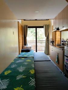 碧瑶Evergreen Suites Cozy Baguio Loft Retreat的一间小房间,厨房内配有两张床