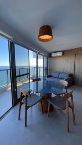 萨尔瓦多Apartamento em Ondina com acesso à praia (Beach Class Salvador)的客厅配有桌椅和沙发