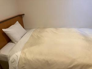 挂川市Hotel Kakegawa Hills的一张白色的床,上面有枕头