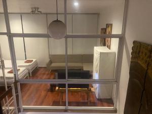 曼谷420 House- up to 10 guests in central Bangkok.的透过窗户可欣赏到配有沙发的房间的景色