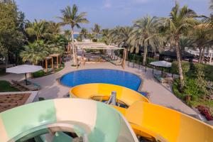 拉斯阿尔卡麦哈伊马角华尔道夫酒店的一个带游泳池和棕榈树的度假村