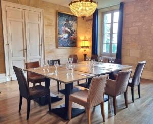 皮斯甘Château Fleur de Roques - Puisseguin Saint Emilion的用餐室配有大型木桌和椅子