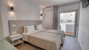 阿尔布费拉Guest House Dianamar的一间卧室设有一张床和一个大窗户