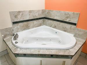 圣安东尼奥Pecan Valley Inn & Suites的浴室内设有大型白色浴缸。