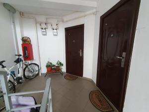 弗洛雷什蒂Stejarului Apartament的走廊上设有两扇棕色的门和自行车