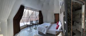瓦迪拉姆Bacific camp的一间卧室设有一张床和一个大窗户