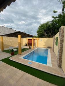圣玛尔塔HERMOSA CASA CAMPESTRE EN SANTA MARTA的一座带房子的庭院内的大型游泳池