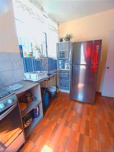 阿雷基帕Fernanda apartment的带冰箱的厨房和木地板