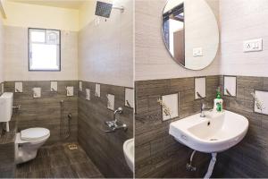 浦那FabHotel Majestic Luxurious的一间带水槽、卫生间和镜子的浴室